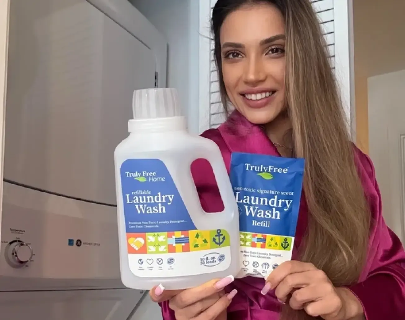 Creator holding two bottles of Truly Free laundry wash