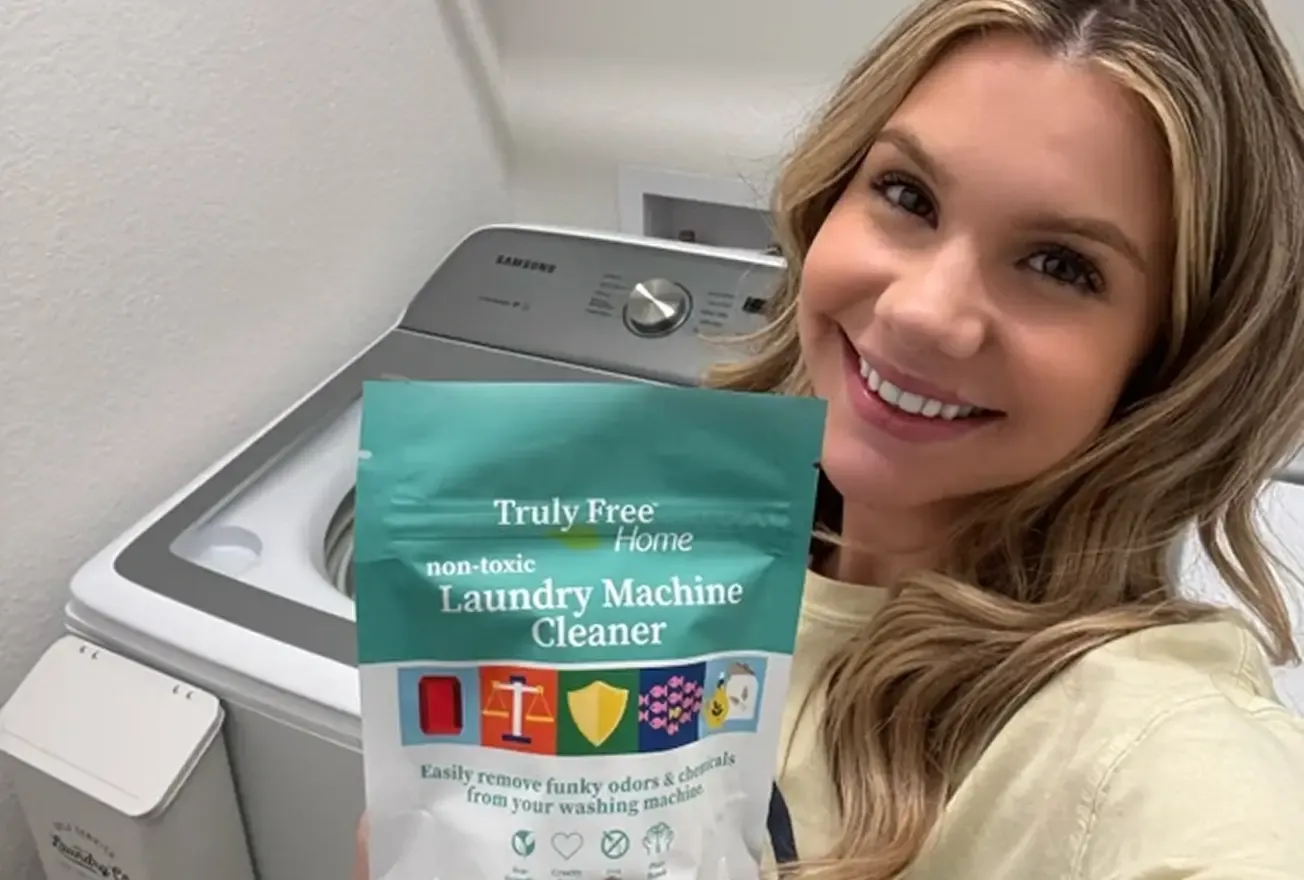 Creator holding Truly Free laundry machine cleaner sachets