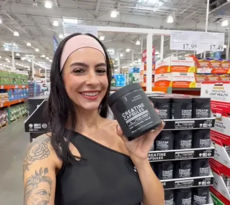 Creator holding a supplement tub in a Costco aisle
