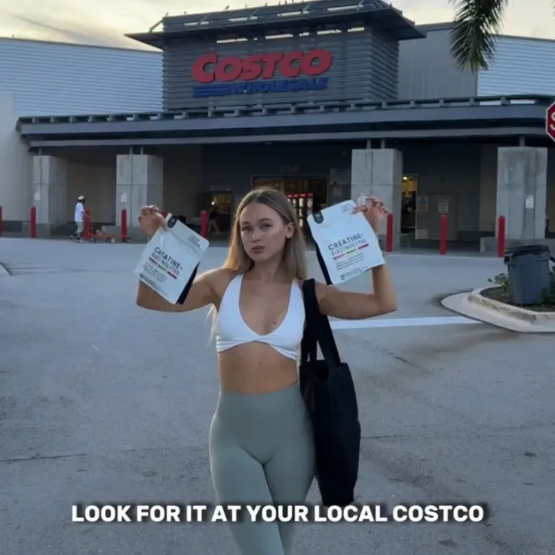Creator holding two product pouches outside a Costco store