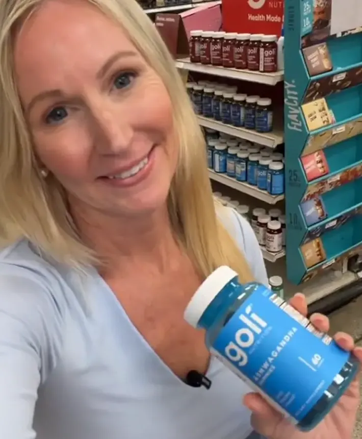 Creator holding Goli gummies in a Target store aisle