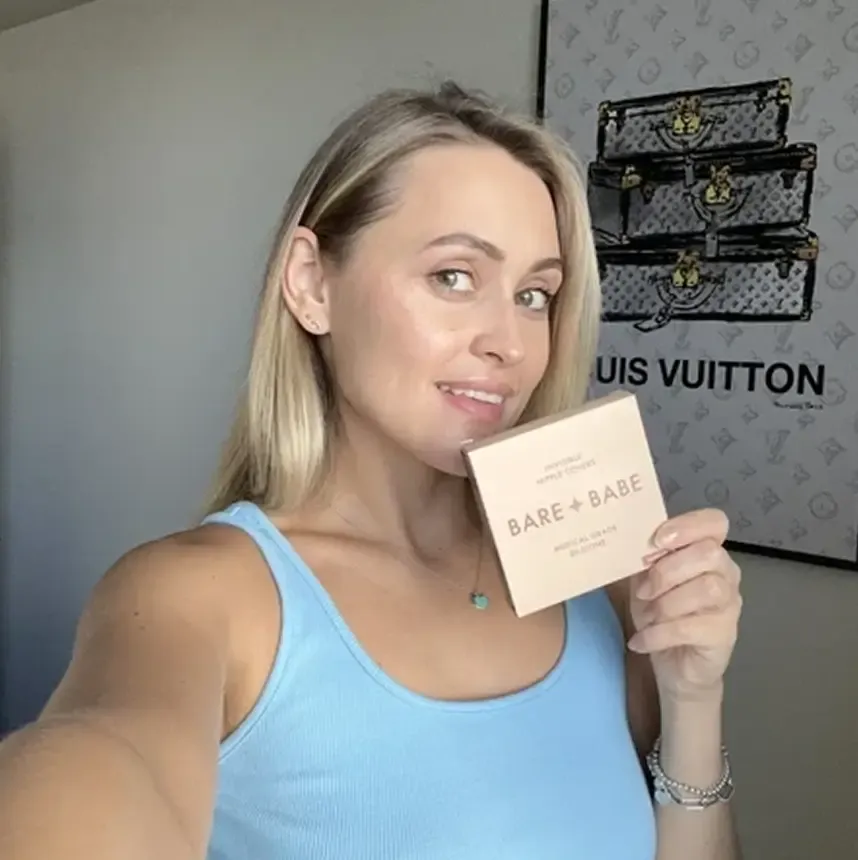 Creator holding a Bare Babe beauty product