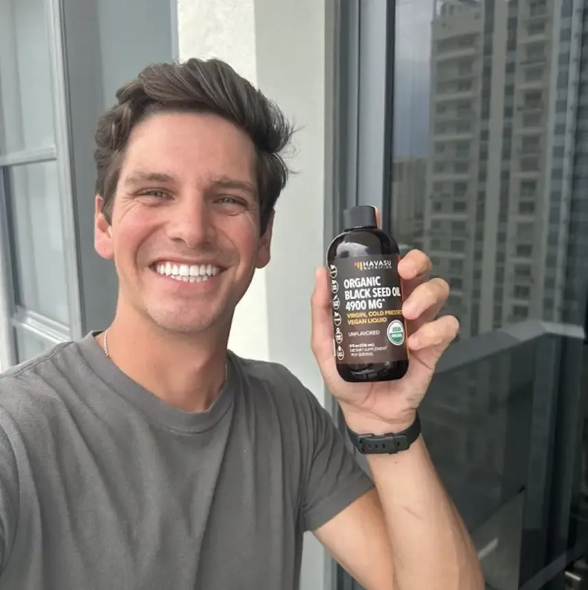 Creator holding a Growve portfolio supplement bottle