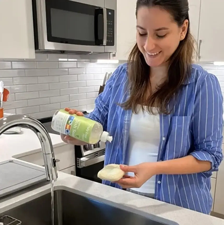 Creator demonstrating Truly Free cleaning products at a sink
