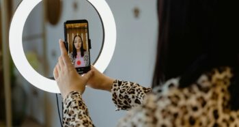 woman using a smartphone and a right light