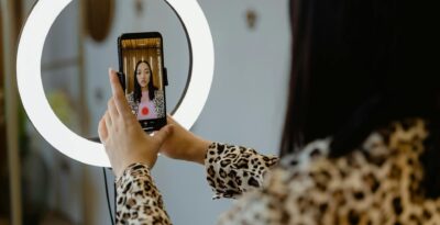 woman using a smartphone and a right light