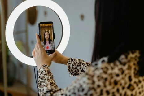woman using a smartphone and a right light
